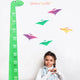 little gril next to a dinosaur height chart wall sticker