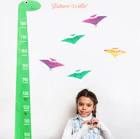 little gril next to a dinosaur height chart wall sticker